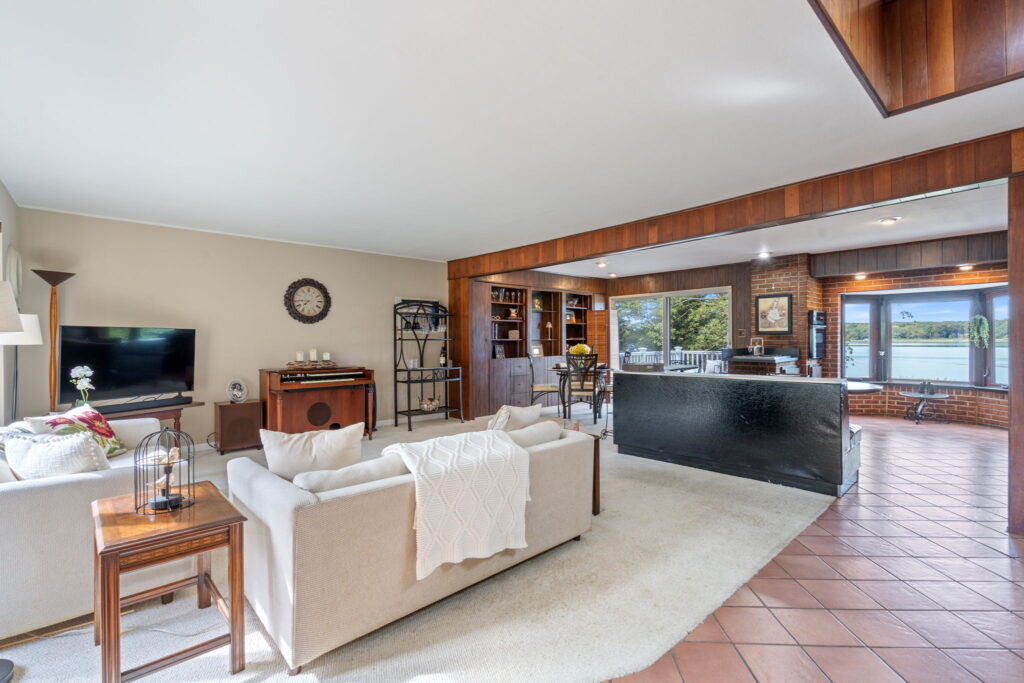 a living room with a kitchen and a large table
