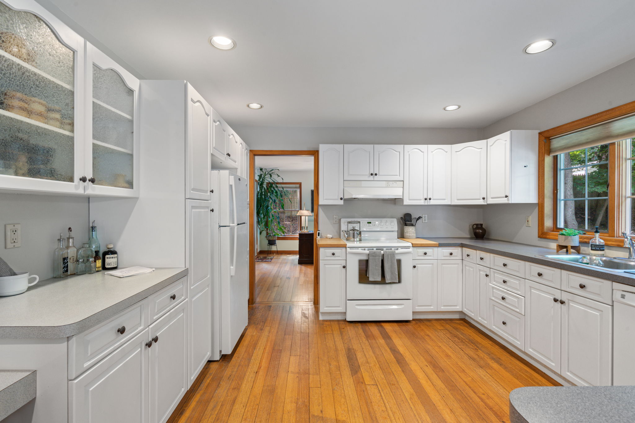 Spacious kitchen with white cabinetry at 470 Pond Path East Setauket NY