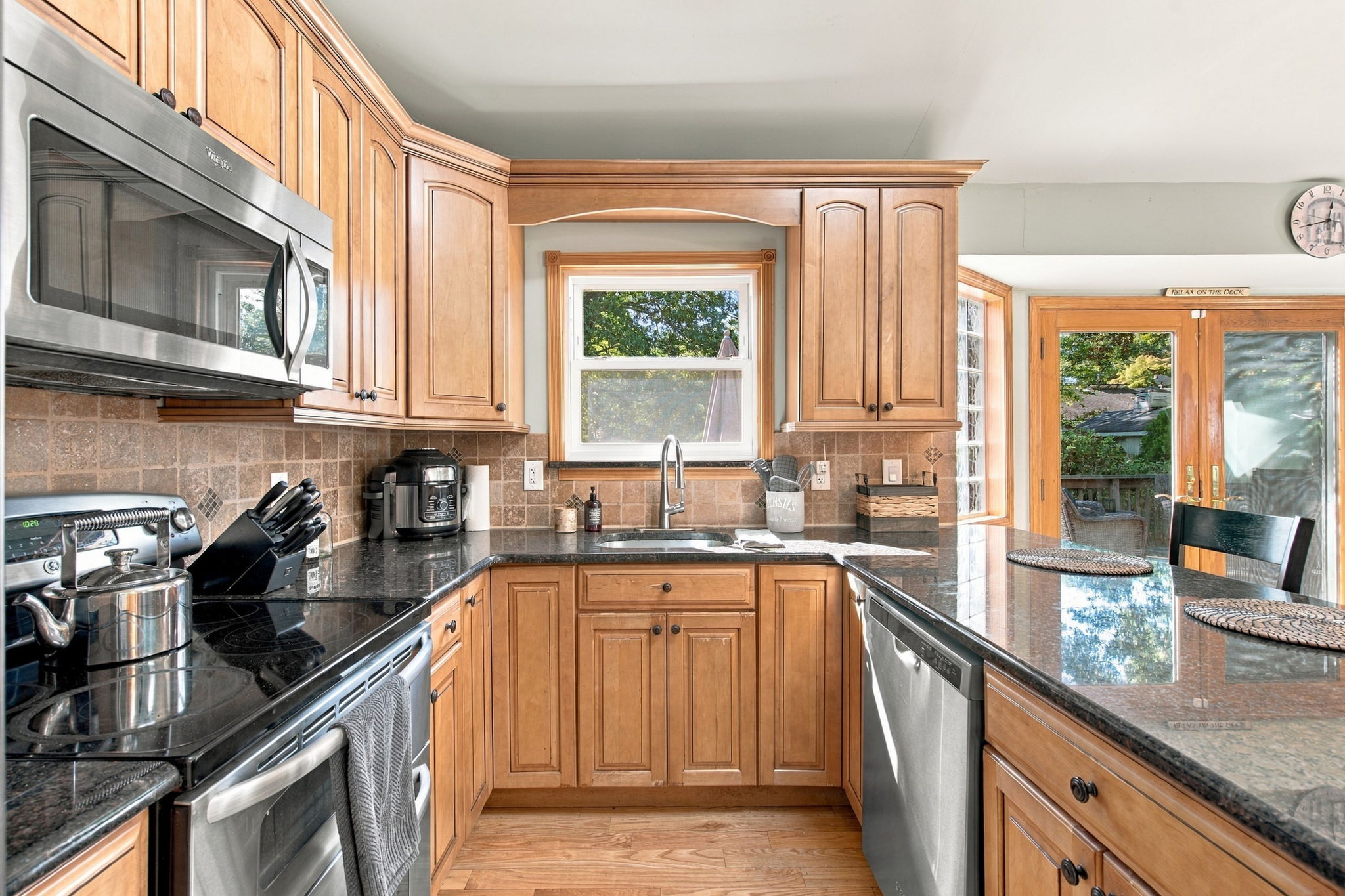 Eat in kitchen with cathedral ceiling stainless steel appliances and granite countertops at 46 Cedar Street Selden NY
